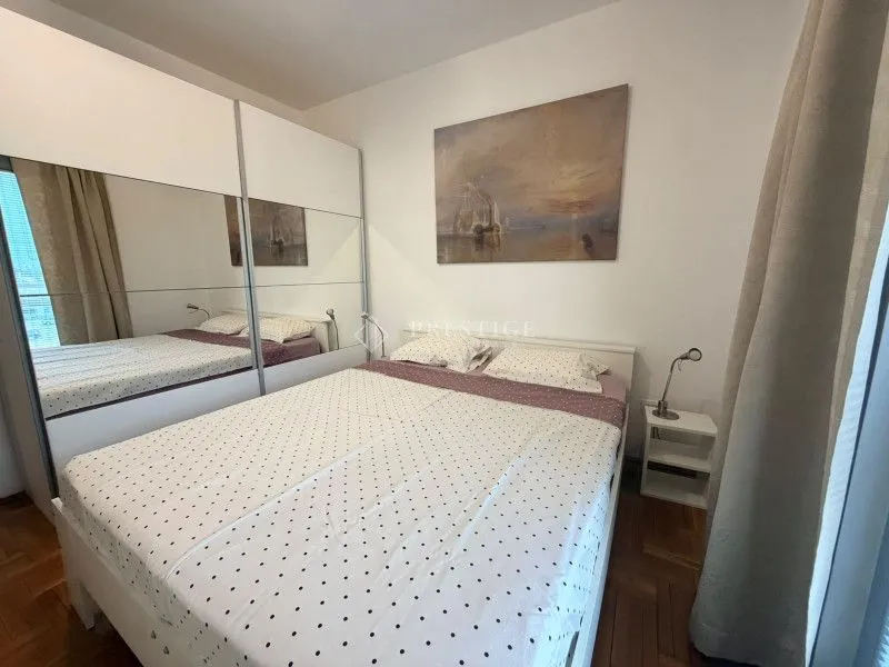 Furnished bedroom with a large double bed and wardrobe.
