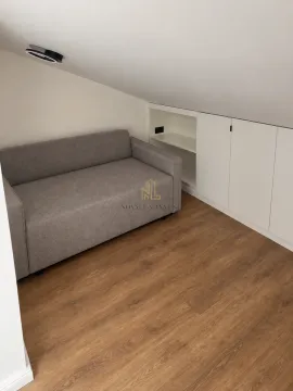 Manji dnevni boravak sa sivim kaučem i ugradnim plakarom ispod krovne kosine. - image 3