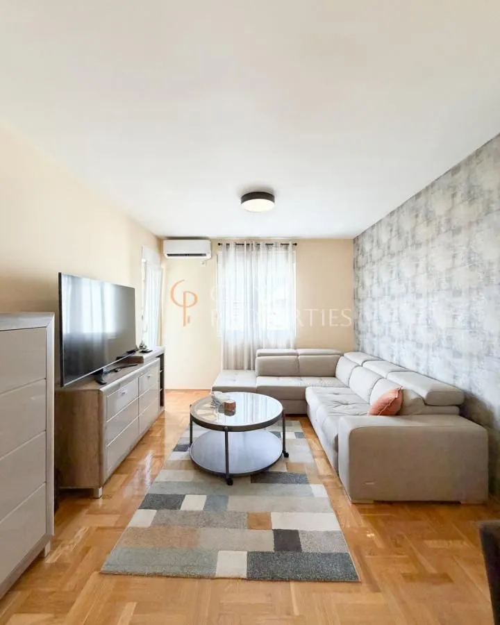 Living room with a corner sofa, television, and a coffee table.