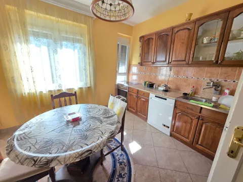 Dining area and kitchen with wooden cabinets and a dining table. - image 10