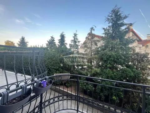 View from the paved balcony surrounded by greenery and trees. - image 2