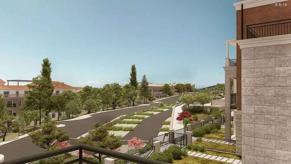 View from the terrace overlooking a landscaped complex and surrounding greenery.