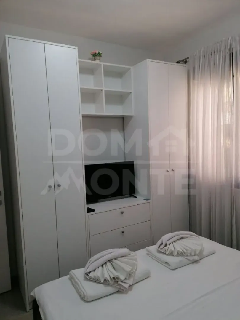 Furnished bedroom with white wardrobes and a double bed.