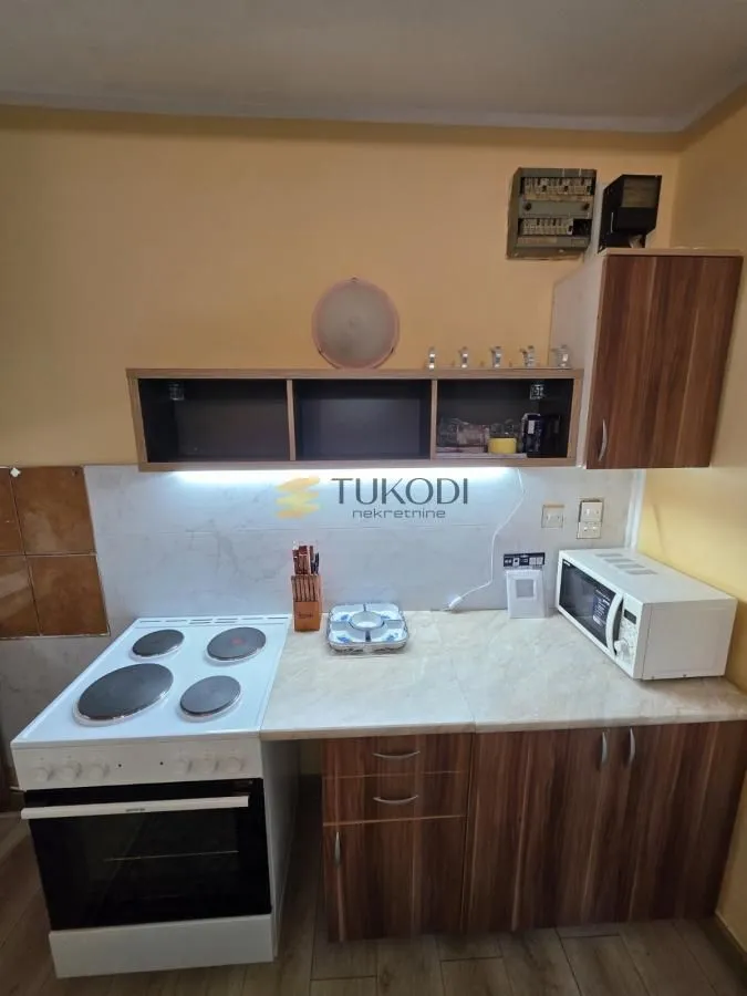 Small kitchen with a stove, counter space, and wall cabinets.