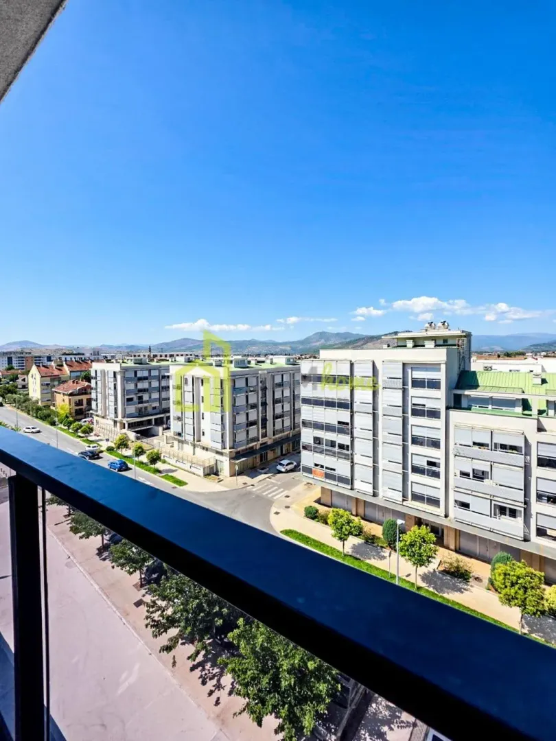 View from the terrace overlooking city streets and surrounding buildings.