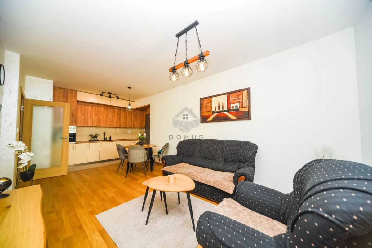Living room with sofa set and dining area integrated with the kitchen.
