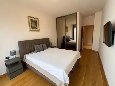 Uređena spavaća soba sa bračnim krevetom, plakarom i TV-om. - image 4