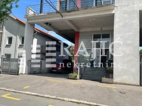 Exterior of the commercial building with entrance and parking space. - image 3