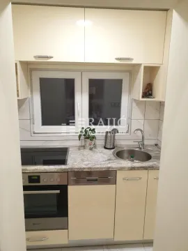 Small kitchen with built-in appliances, sink, and window. - image 9