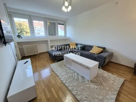 Living room with a sofa and parquet flooring. - image 2