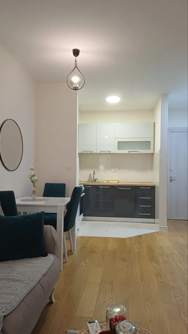 Living room with dining area and kitchen in the background.