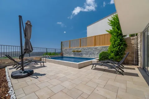 Modern terrace with a swimming pool and sun loungers. - image 5