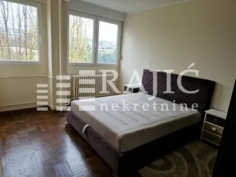 Bedroom with a large double bed and windows overlooking greenery. - image 8