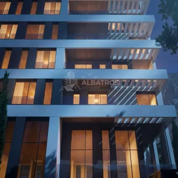 Night view of the facade of a modern apartment building with illuminated windows and balconies. - image 2