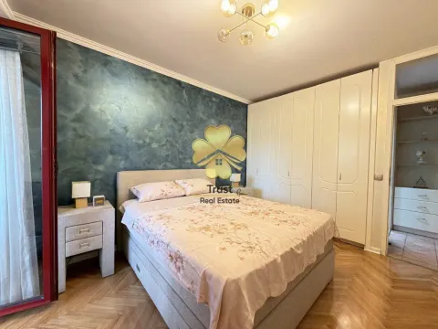 Spacious bedroom with a double bed, wardrobe, and a dark accent wall. - image 13