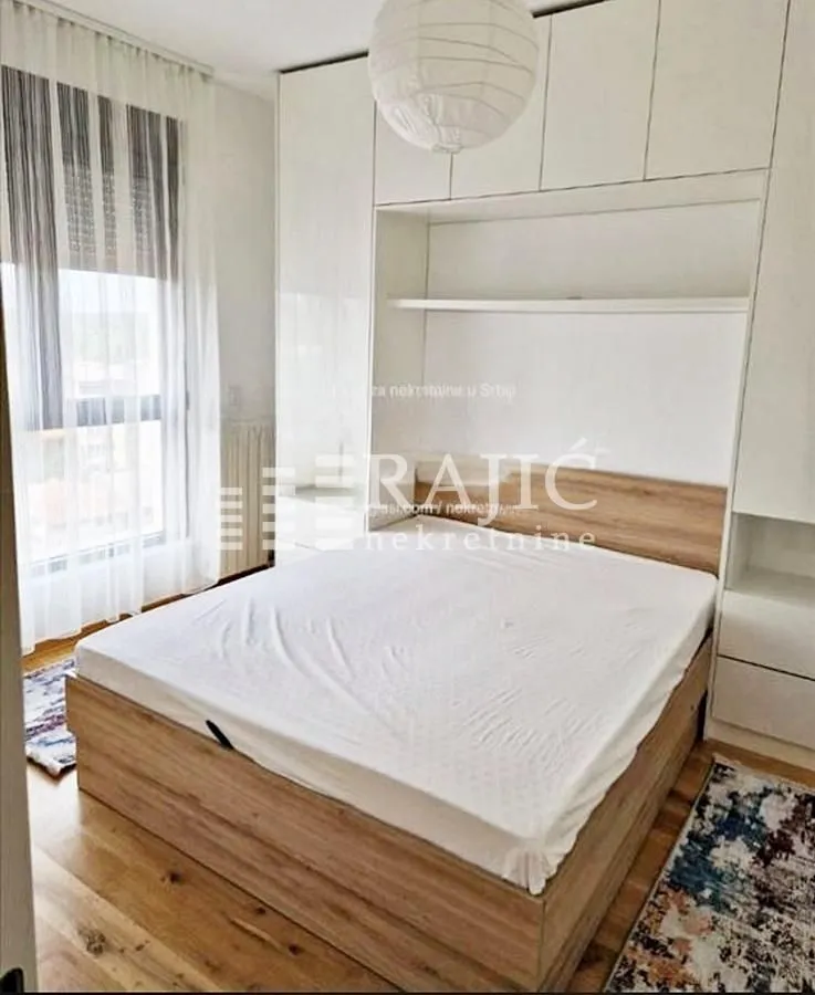 Furnished bedroom with a double bed and built-in wardrobes.
