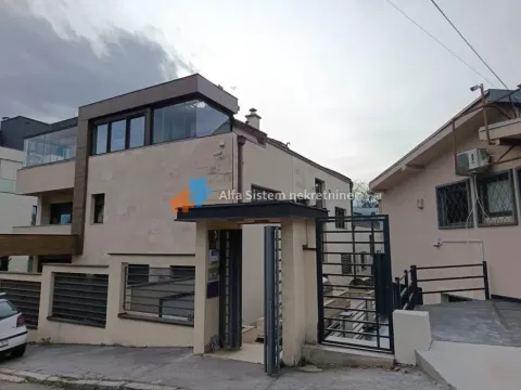 View of the building exterior with entrance gate and fence. - image 2