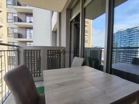 Spacious covered terrace with a table and chairs and a view of buildings. - image 15
