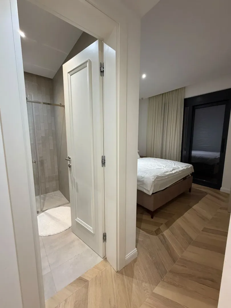 View from the hallway into the bedroom and bathroom.