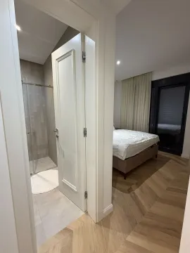 View from the hallway into the bedroom and bathroom. - image 6
