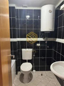 Smaller bathroom with black wall tiles and sanitary ware. - image 7