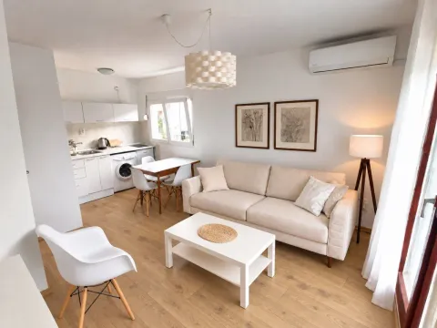 Living room with dining area and kitchen in light tones. - image 6