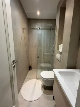 Modernly equipped bathroom with a shower cabin and a sink. - image 13