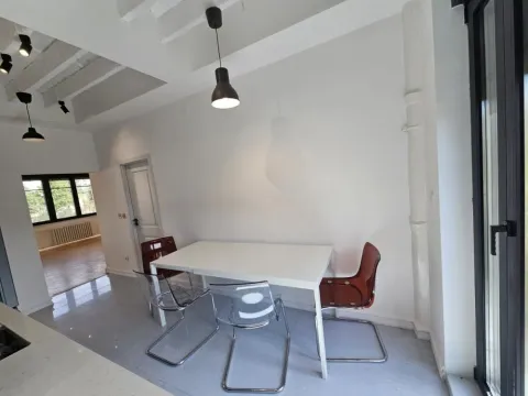 Dining area with a white table and modern chairs in a bright interior. - image 4