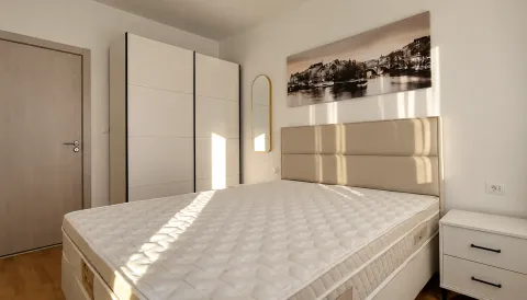 Bedroom with a double bed, white wardrobe, and a bedside table. - image 5