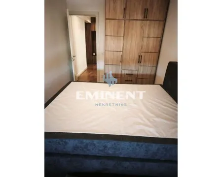 Furnished bedroom with a double bed and built-in wardrobe. - image 10