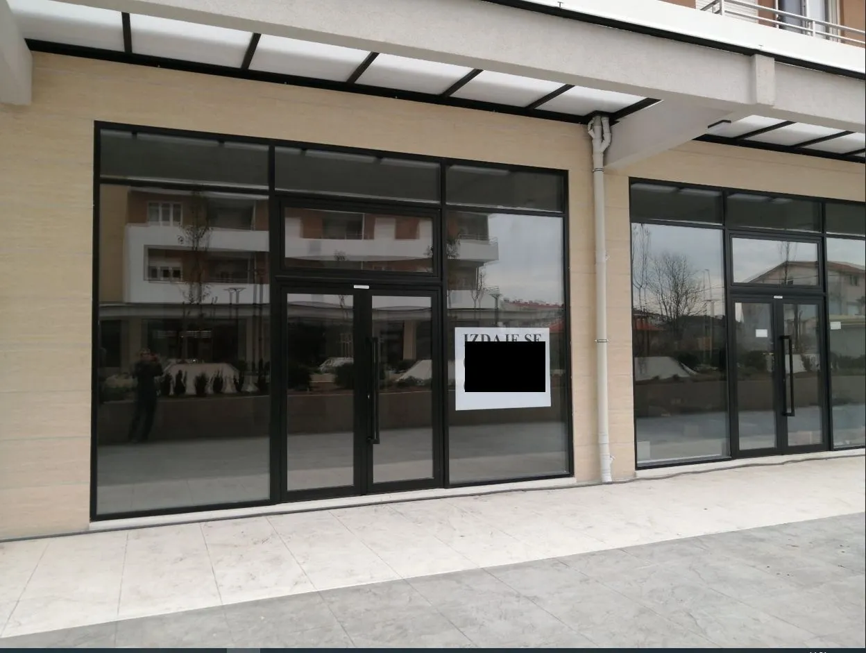 Exterior view of a commercial space with large glass storefronts.