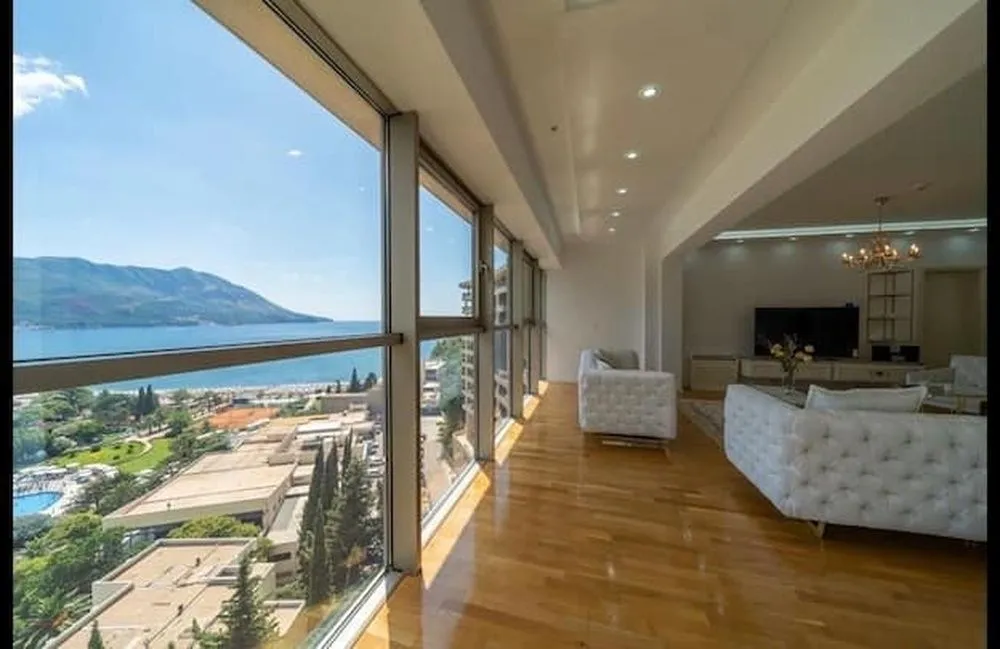 Spacious living room with large glass surfaces and a sea view.