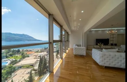 Spacious living room with large glass surfaces and a sea view. - image 8