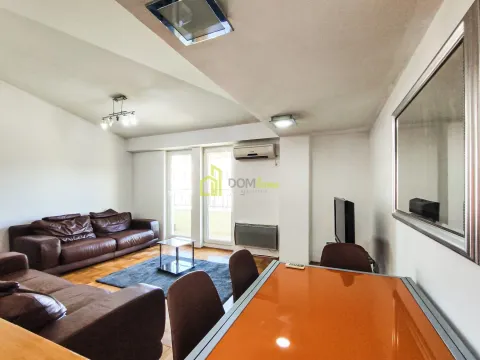 Living room with seating furniture and a dining area. - image 7