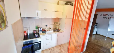 Small kitchen with white cabinets and a stove. - image 6