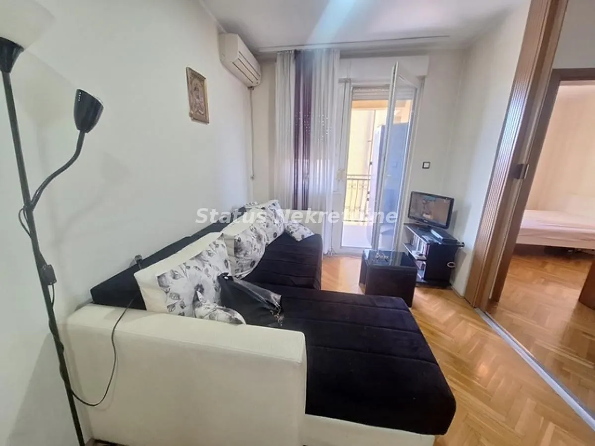 Dnevna soba sa garniturom i izlazom na terasu.