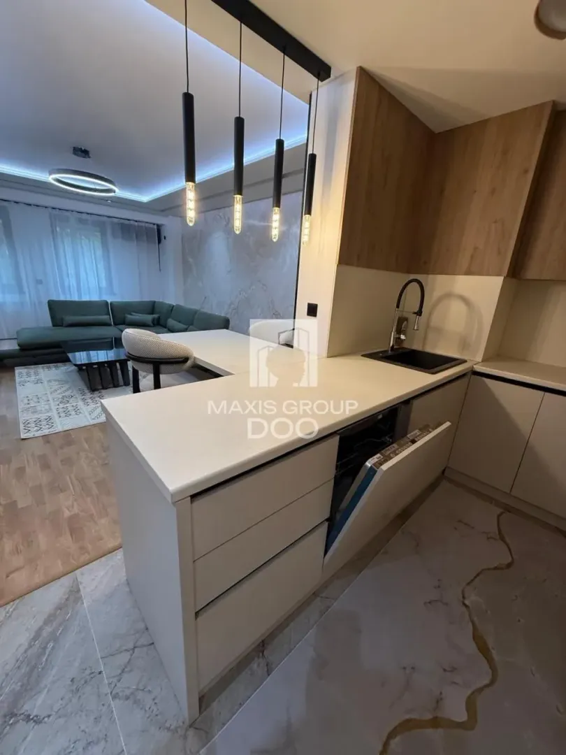 Modern kitchen with a breakfast bar and an open view of the living room.
