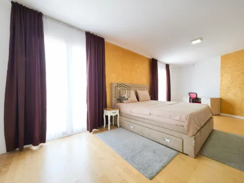 Bedroom with a double bed, nightstand, and a desk near the window. - image 9