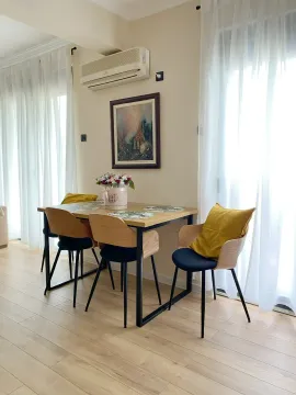 Dining table with chairs in a bright interior near the windows. - image 5