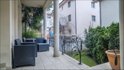 Covered terrace with seating furniture and a view of the courtyard. - image 2