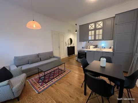 Living room with open-plan kitchen and dining area. - image 2