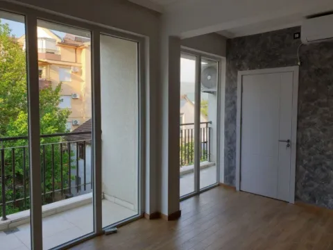 Bright empty room with large glass doors leading to balconies. - image 10