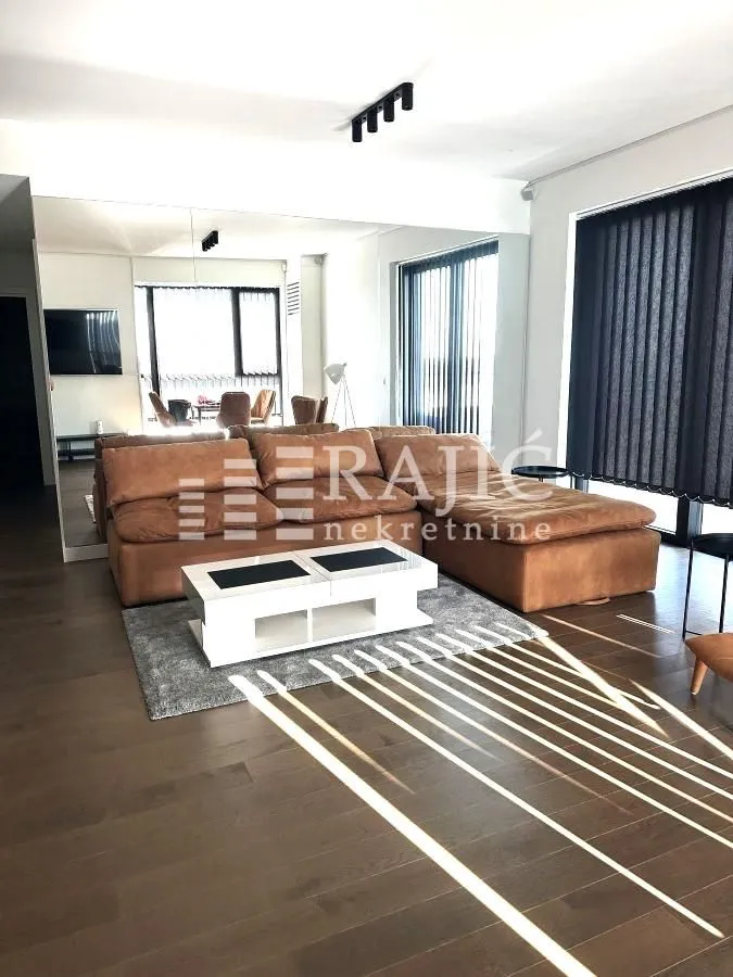 Living room with sofa and a large wall mirror.