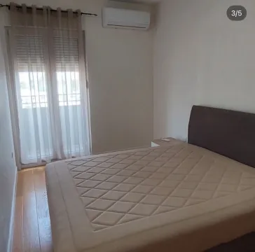 Bedroom with a double bed, air conditioning, and balcony access. - image 3