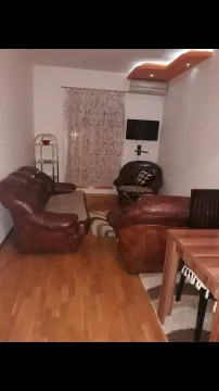 Living room with leather furniture and wooden flooring. - image 10