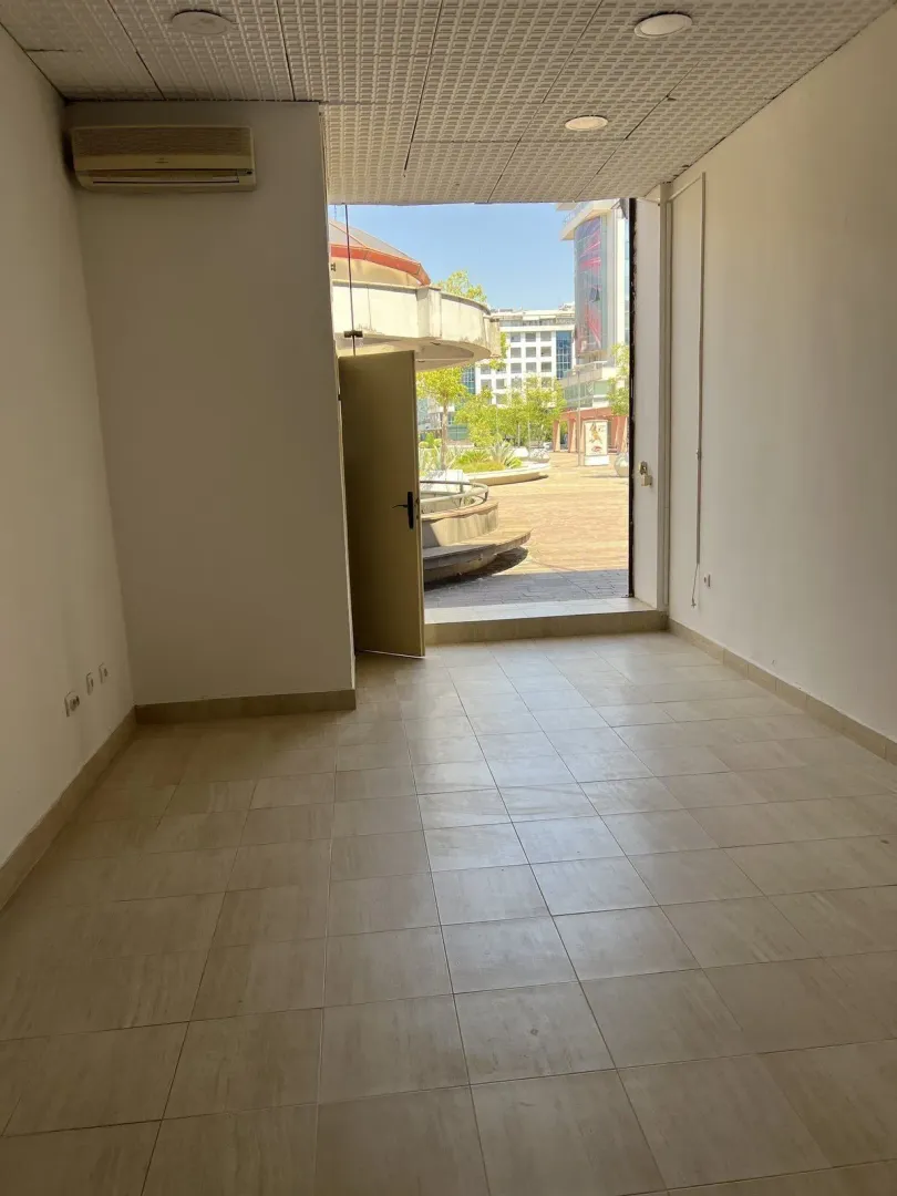 An empty commercial space with tiled floors and an open entrance.