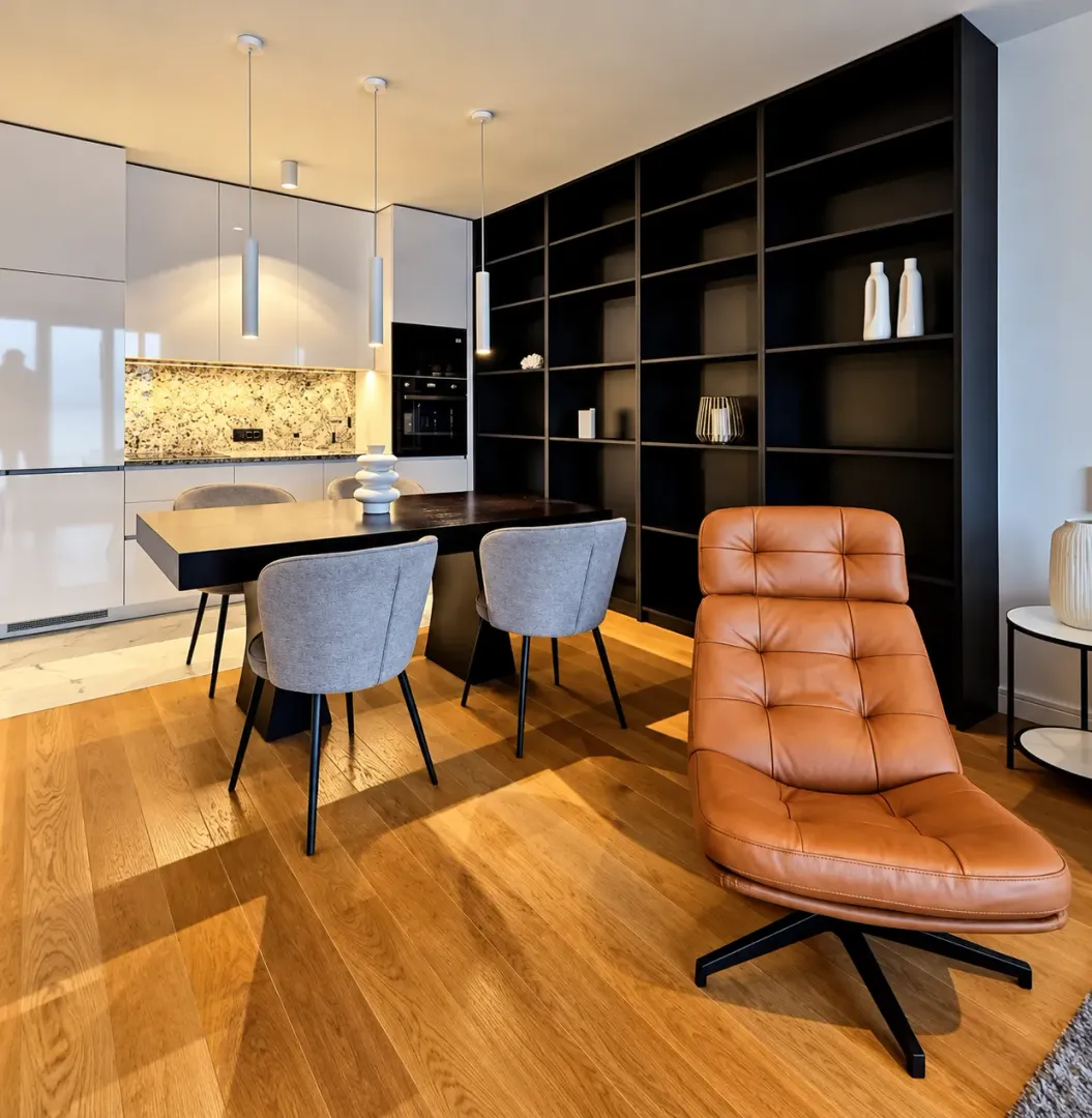 Living room with a dining area and a modern kitchen in the background.
