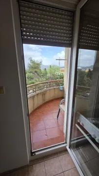 View of a semi-circular tiled balcony through an open door. - image 17