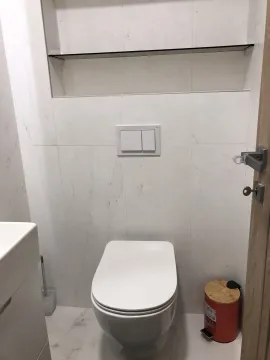 Modern toilet with white tiles. - image 29