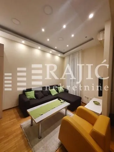 Living room with sofa, armchair and coffee table.